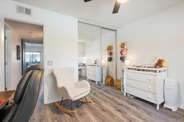 office space with visible vents, a ceiling fan, and wood finished floors