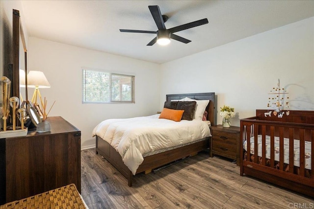 bedroom featuring baseboards, ceiling fan, and wood finished floors