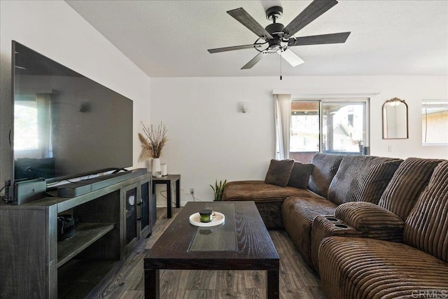 living room with a ceiling fan and dark wood-style flooring