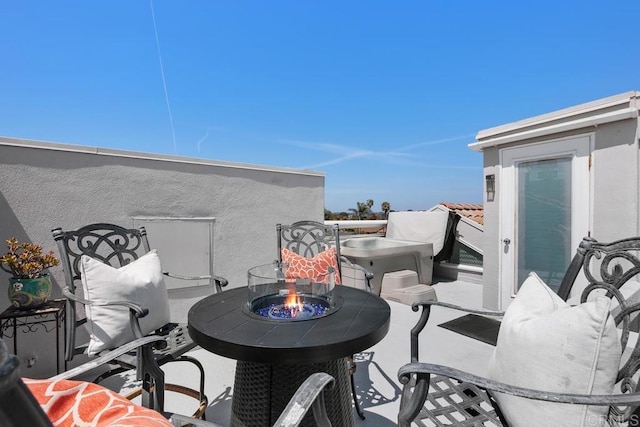 balcony featuring a patio and a fire pit