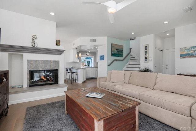 living area with visible vents, wood finished floors, stairway, recessed lighting, and a ceiling fan