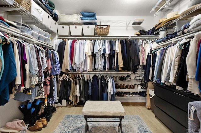 spacious closet featuring visible vents and wood finished floors