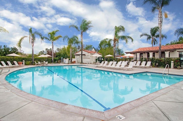 pool featuring fence and a patio