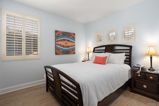 bedroom with baseboards and light wood-style floors