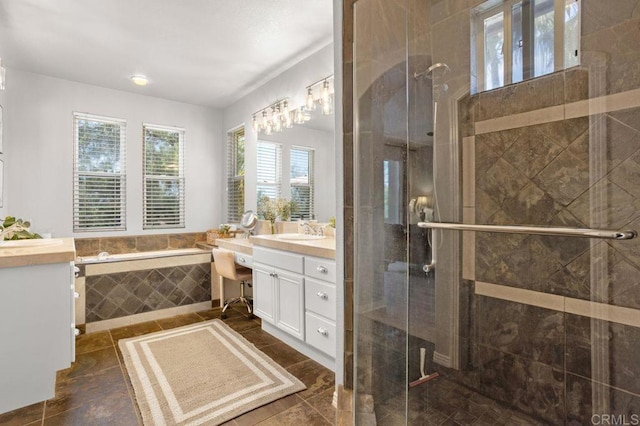 full bath with vanity, plenty of natural light, and a stall shower