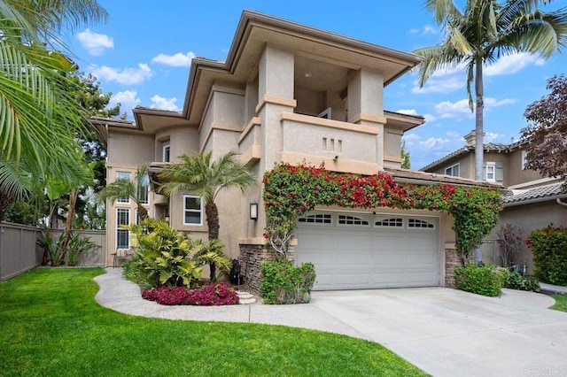 view of front of home with fence, an attached garage, a front lawn, stucco siding, and driveway