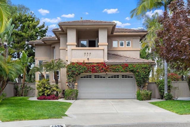 view of front of house with fence, stucco siding, and concrete driveway