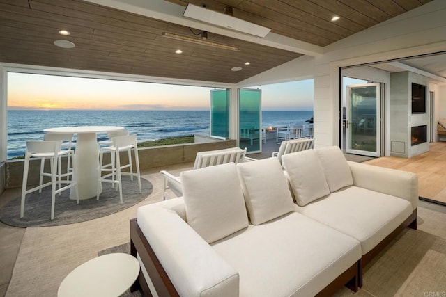 balcony featuring a water view and outdoor lounge area