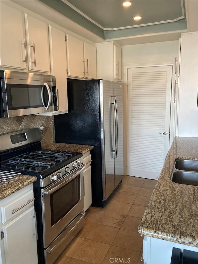 kitchen featuring stone countertops, recessed lighting, white cabinetry, tasteful backsplash, and appliances with stainless steel finishes