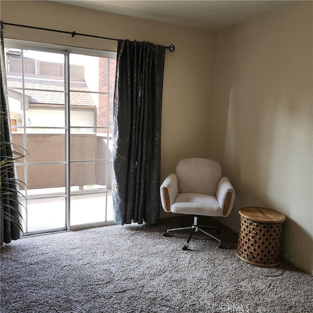 sitting room featuring baseboards and carpet flooring