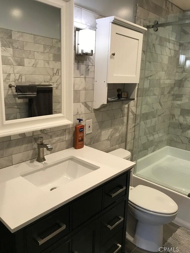 full bath with vanity, backsplash, toilet, and tile walls