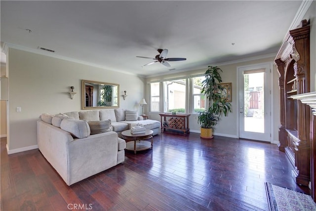 living room featuring a ceiling fan, dark wood-style flooring, visible vents, crown molding, and baseboards