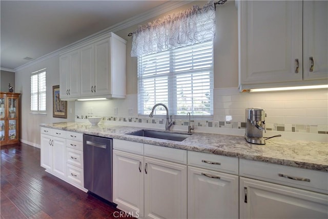 kitchen featuring crown molding, a sink, white cabinetry, stainless steel dishwasher, and dark wood-style floors
