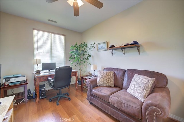 office with visible vents, light wood finished floors, and ceiling fan