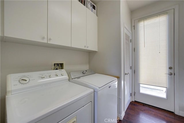 clothes washing area with baseboards, cabinet space, dark wood finished floors, and washing machine and clothes dryer