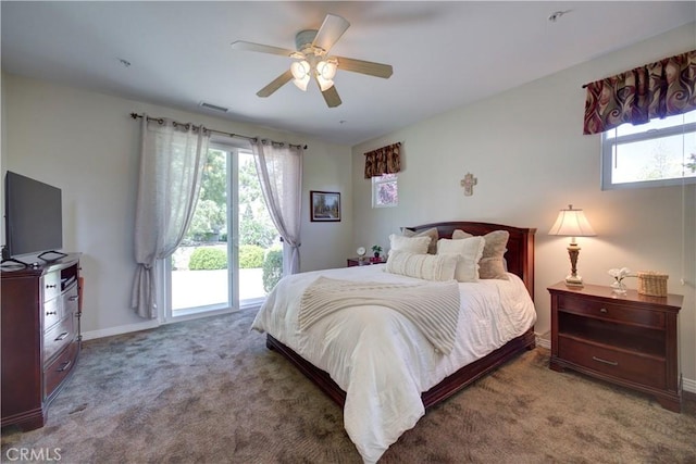 carpeted bedroom with baseboards, visible vents, multiple windows, and access to exterior