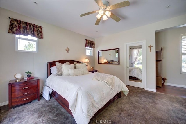 bedroom with multiple windows, a ceiling fan, and carpet flooring