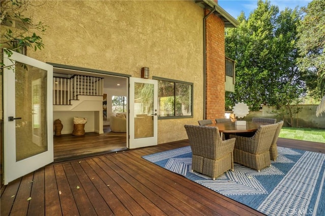 deck featuring fence and outdoor dining area