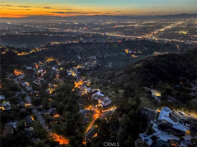 aerial view at dusk featuring a mountain view