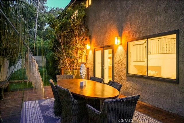 exterior space featuring french doors, outdoor dining area, and a deck