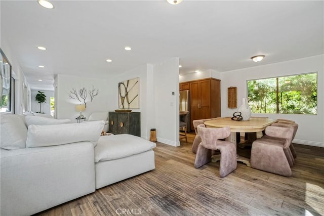living area with baseboards, recessed lighting, and wood finished floors