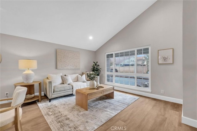 living room with baseboards, recessed lighting, wood finished floors, and high vaulted ceiling