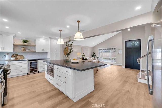 kitchen featuring white cabinets, dark countertops, appliances with stainless steel finishes, open shelves, and wine cooler