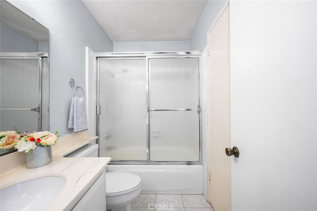 bathroom featuring vanity, bath / shower combo with glass door, tile patterned flooring, and toilet