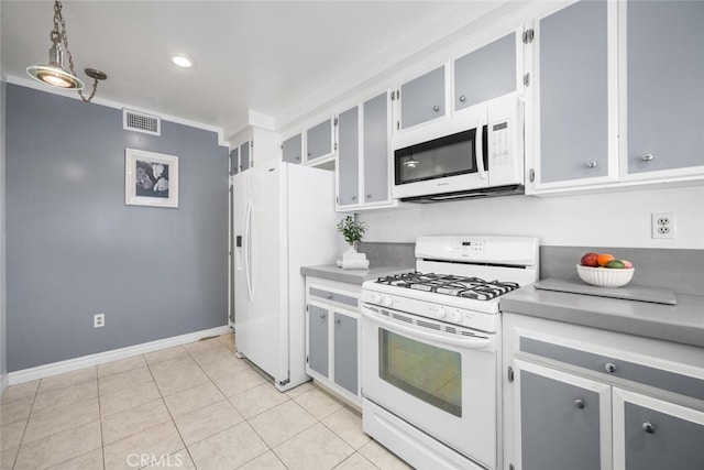 kitchen featuring visible vents, light countertops, light tile patterned floors, and white appliances