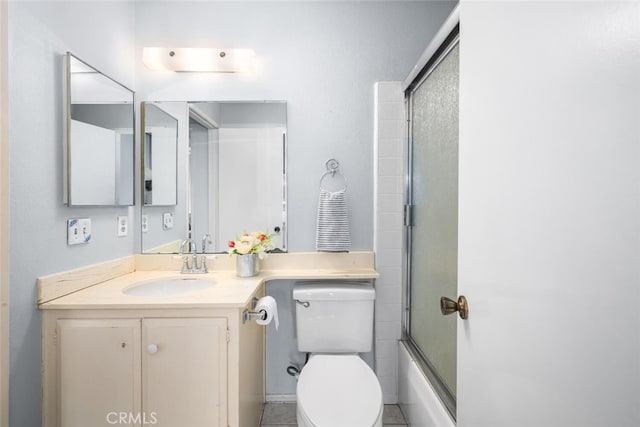 full bathroom with vanity, shower / bath combination with glass door, and toilet