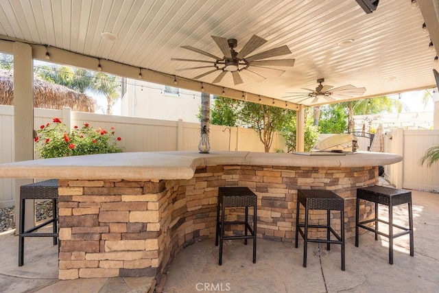 view of patio / terrace featuring a fenced backyard and outdoor dry bar