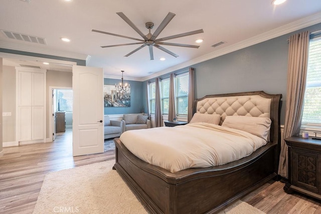 bedroom featuring crown molding, visible vents, and light wood-type flooring