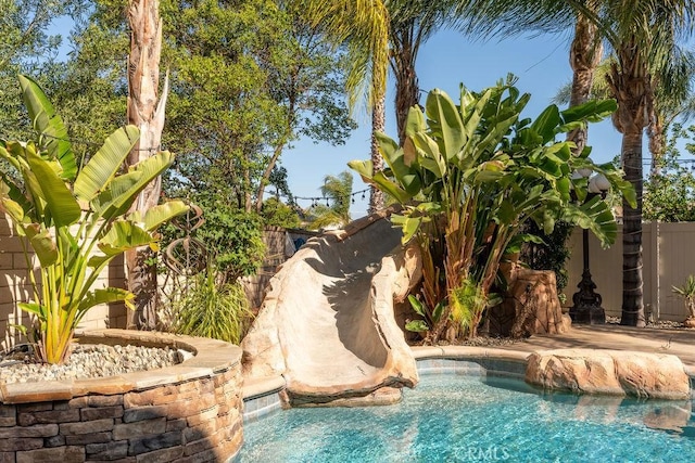 view of swimming pool featuring a fenced in pool and a fenced backyard
