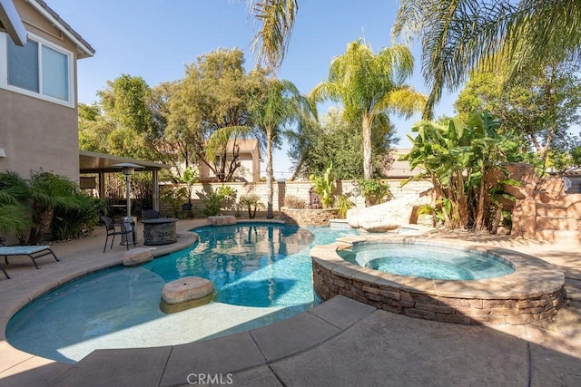 view of pool with a fenced in pool, a fenced backyard, an in ground hot tub, and a patio area