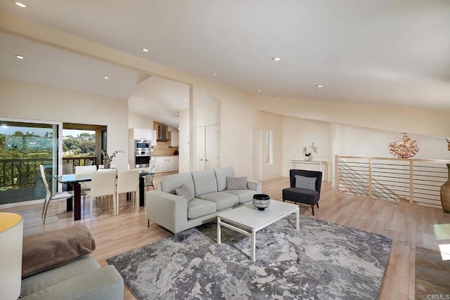 living room featuring recessed lighting, light wood-style flooring, and lofted ceiling