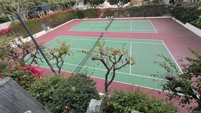 view of tennis court featuring fence