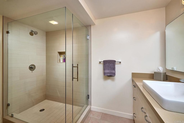 full bathroom with vanity, tile patterned floors, baseboards, and a shower stall