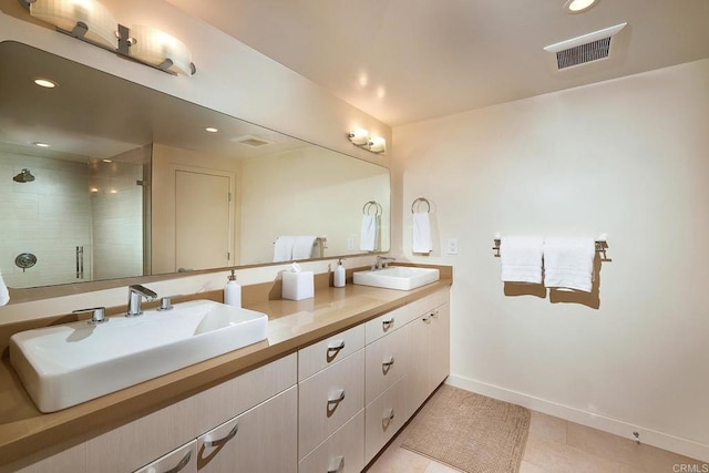bathroom with visible vents, a sink, and a stall shower
