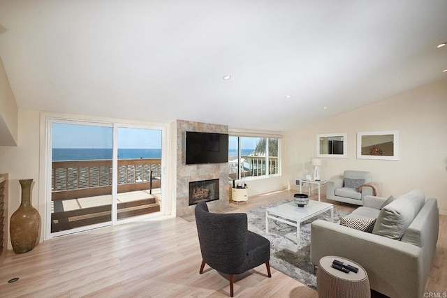 561 S Sierra Ave Unit 34, Solana Beach, CA 92075 - living area featuring light wood-type flooring, vaulted ceiling, and a large fireplace