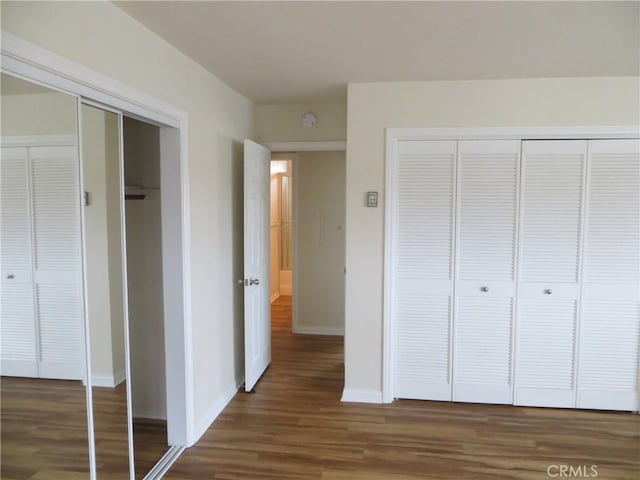 unfurnished bedroom featuring baseboards and wood finished floors