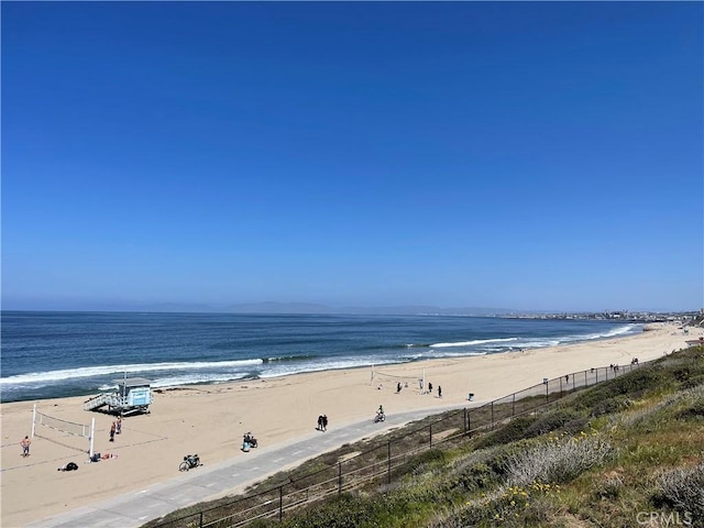 property view of water with a beach view and fence