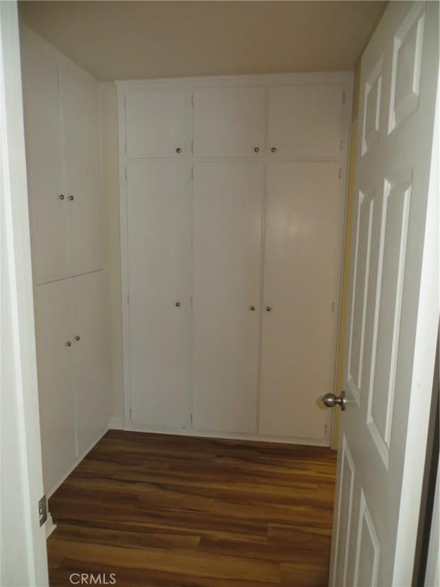 hall with wood finished floors