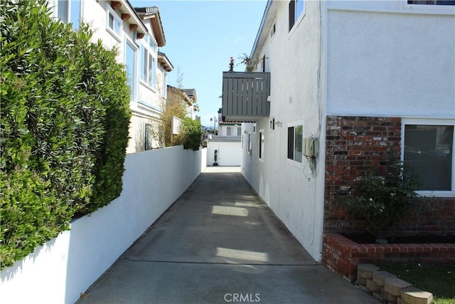 view of side of home with brick siding and stucco siding