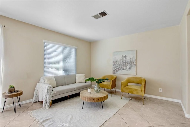 living area featuring visible vents, baseboards, and light tile patterned floors