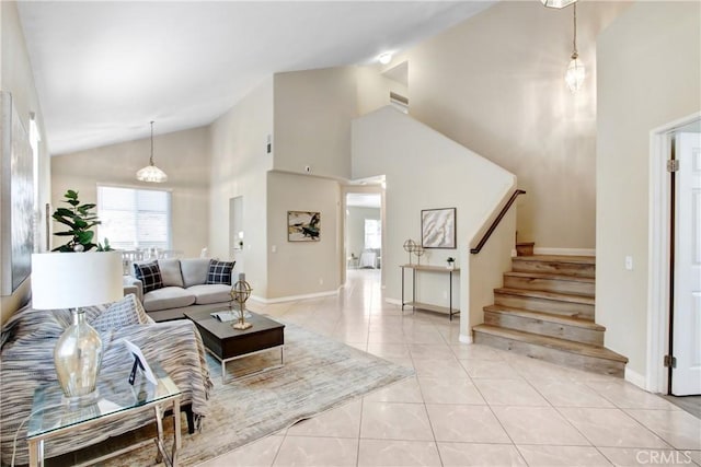 living area with baseboards, stairs, light tile patterned flooring, and high vaulted ceiling