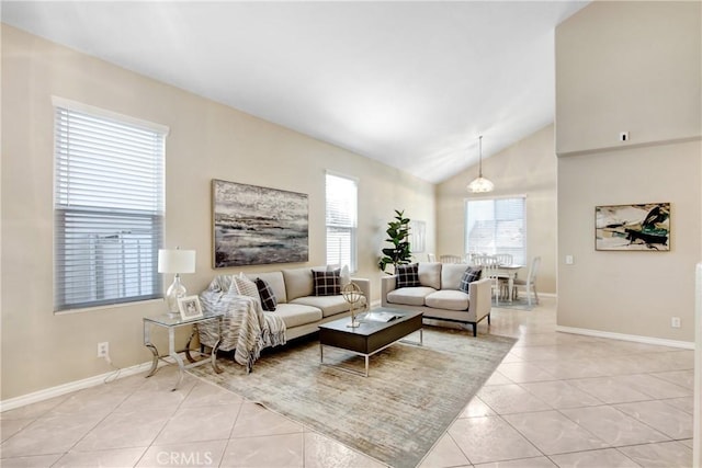 living room with light tile patterned floors, baseboards, and high vaulted ceiling