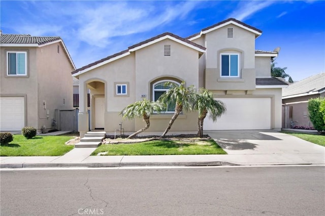 mediterranean / spanish-style home with an attached garage, driveway, and stucco siding