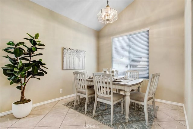 dining space featuring baseboards, a notable chandelier, light tile patterned floors, and high vaulted ceiling