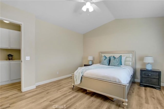 bedroom with baseboards, ceiling fan, light wood-type flooring, and lofted ceiling