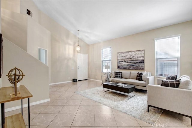 living room featuring baseboards, vaulted ceiling, light tile patterned floors, and visible vents